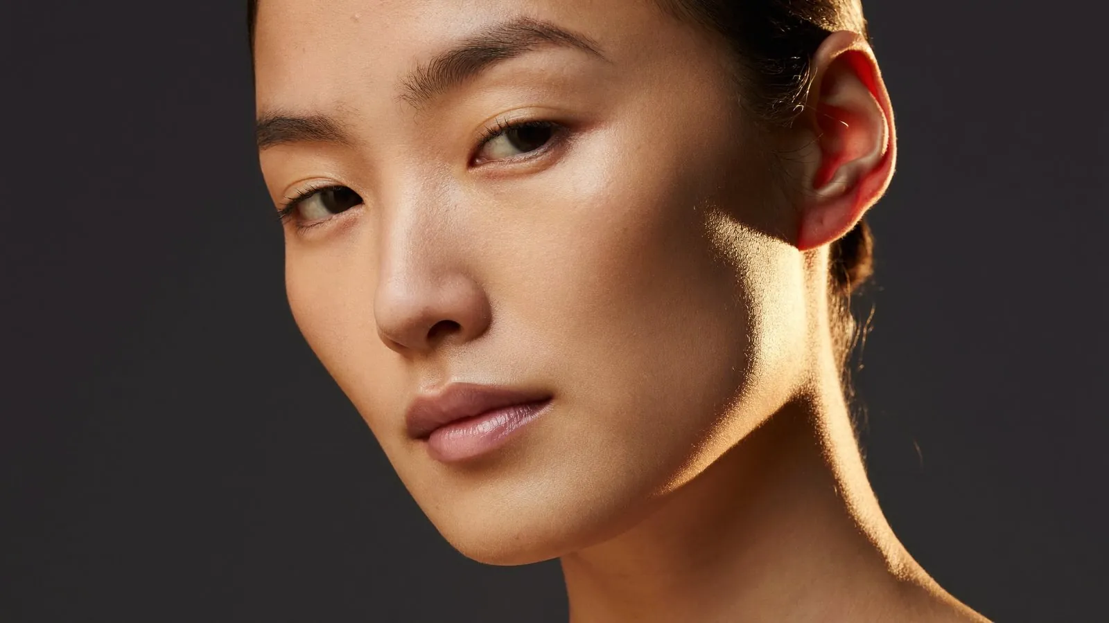 Dr Sin Yong explaining how facial overfilling accumulates across multiple treatments