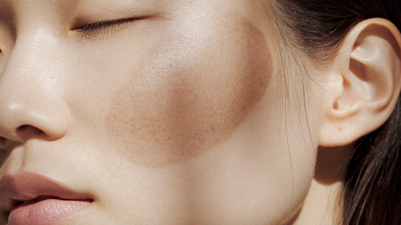 Dr Sin Yong examining facial pigmentation during an assessment