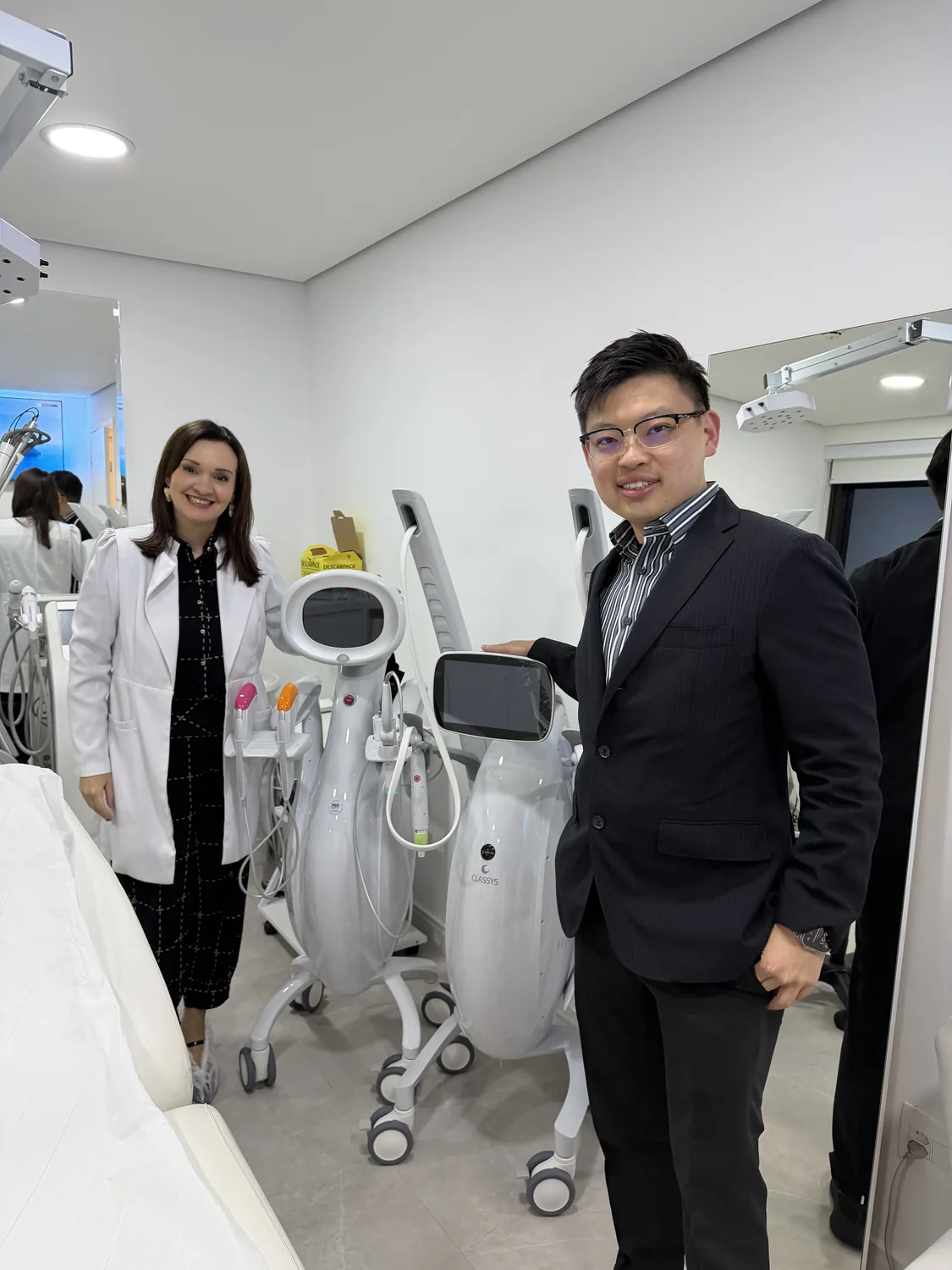 Dr Sin Yong and Dr Renata Violato beside an Ultraformer MPT system in her clinic