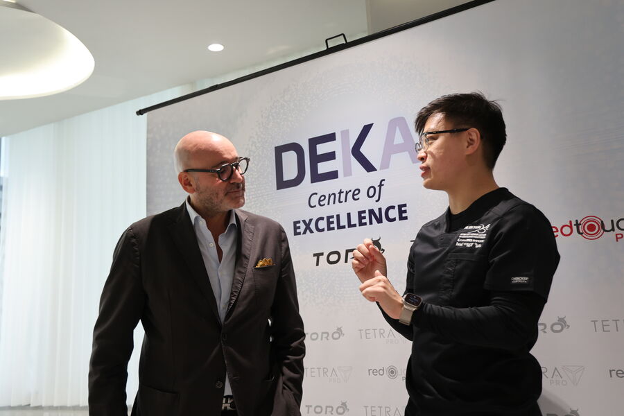 Dr Sin Yong with a DEKA representative at the Centre of Excellence backdrop