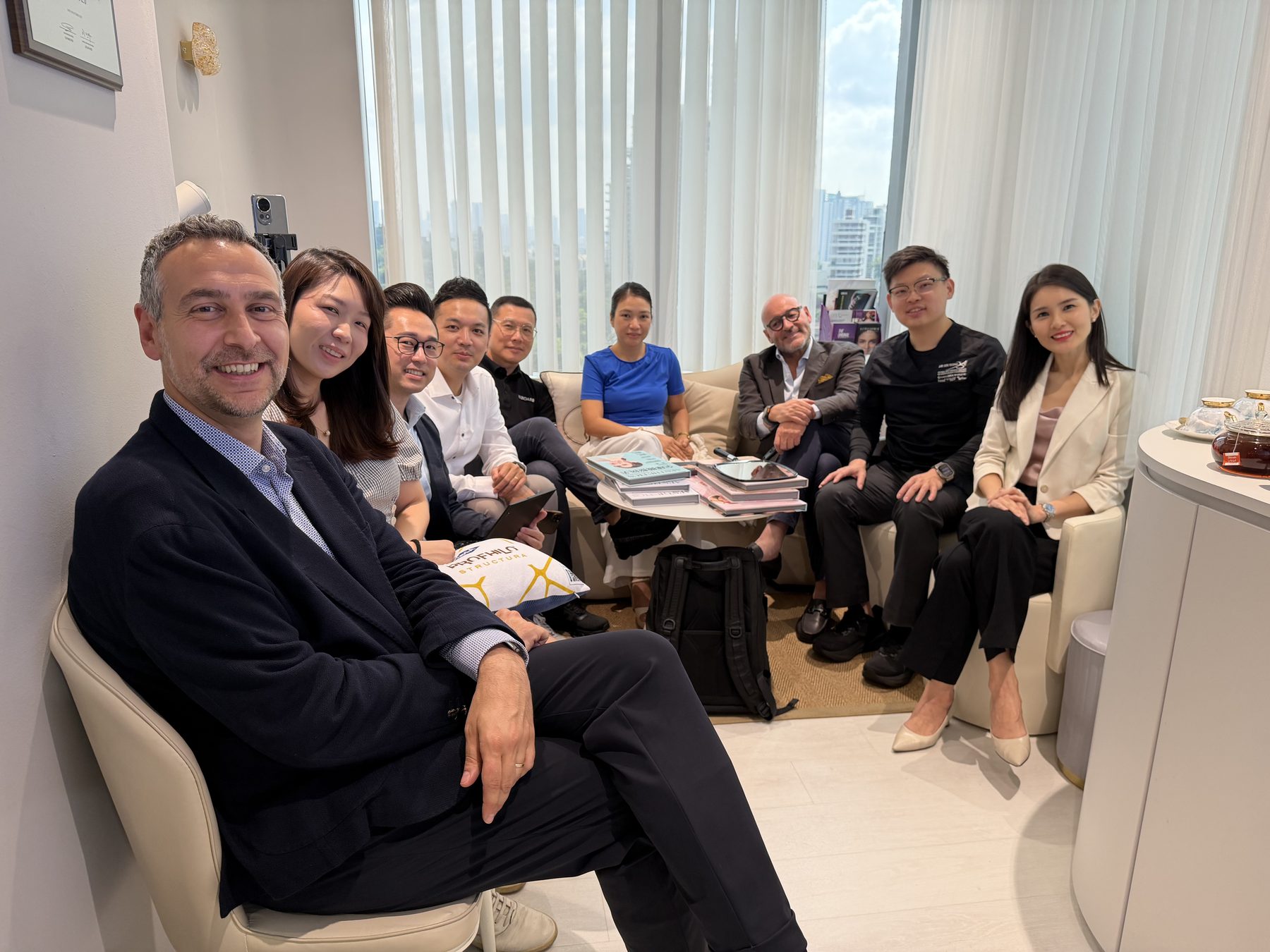 Dr Sin Yong, the DEKA delegation and the clinic team seated in discussion in the consultation room