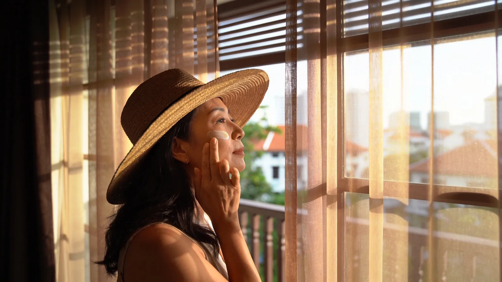 Illustrative model with even facial skin tone in natural light, not a patient