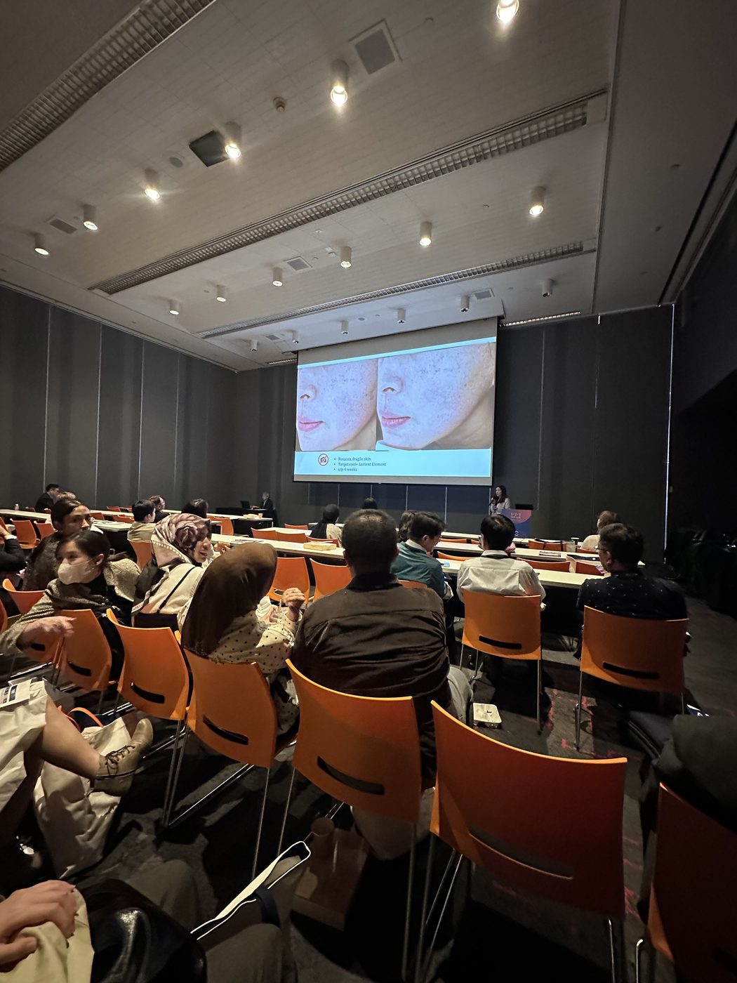 Taiwan doctors in the audience during the AMWC Asia-TDAC 2026 session, with a clinical before-and-after slide on screen